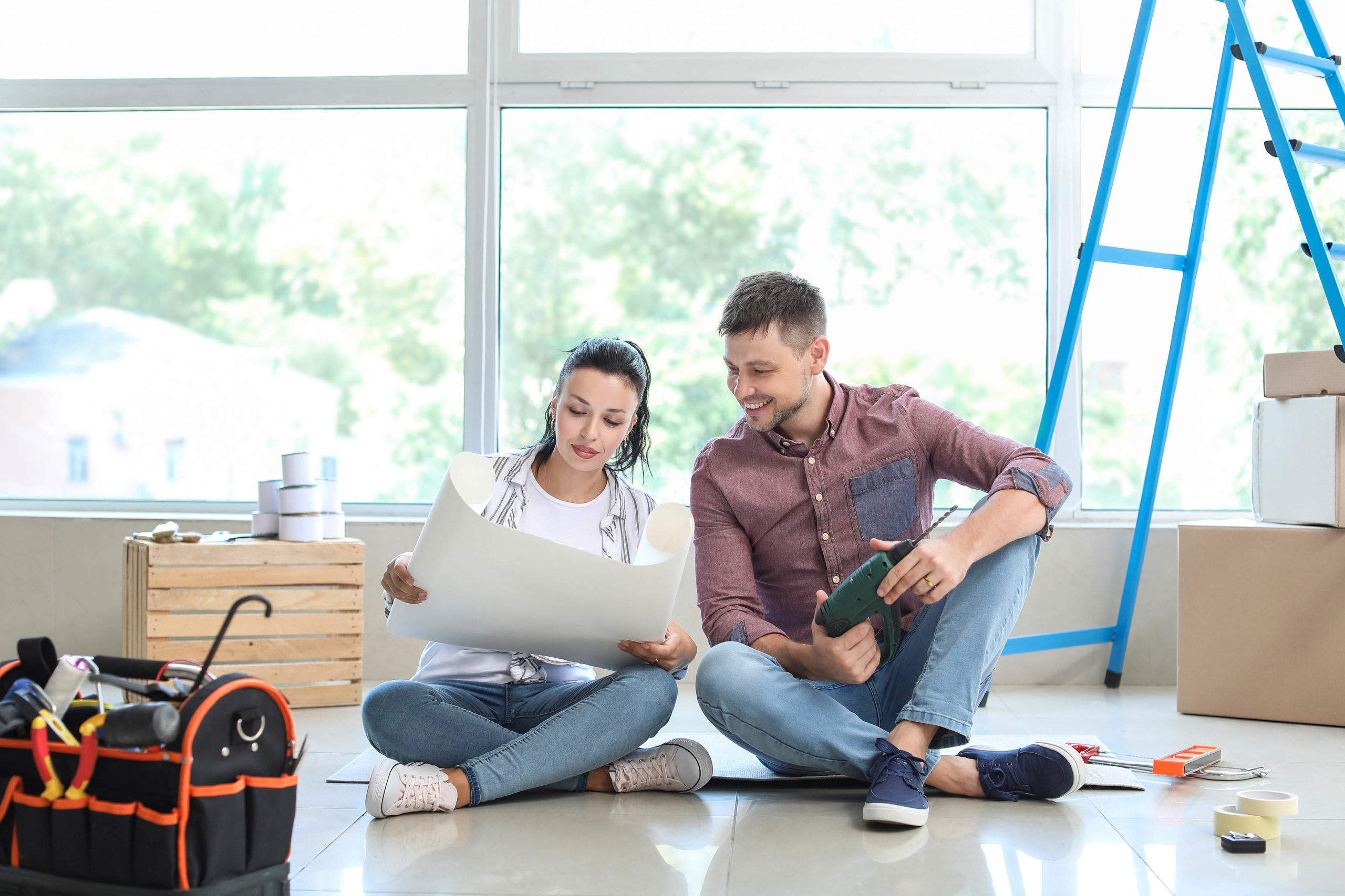 Happy couple doing repair in their new house