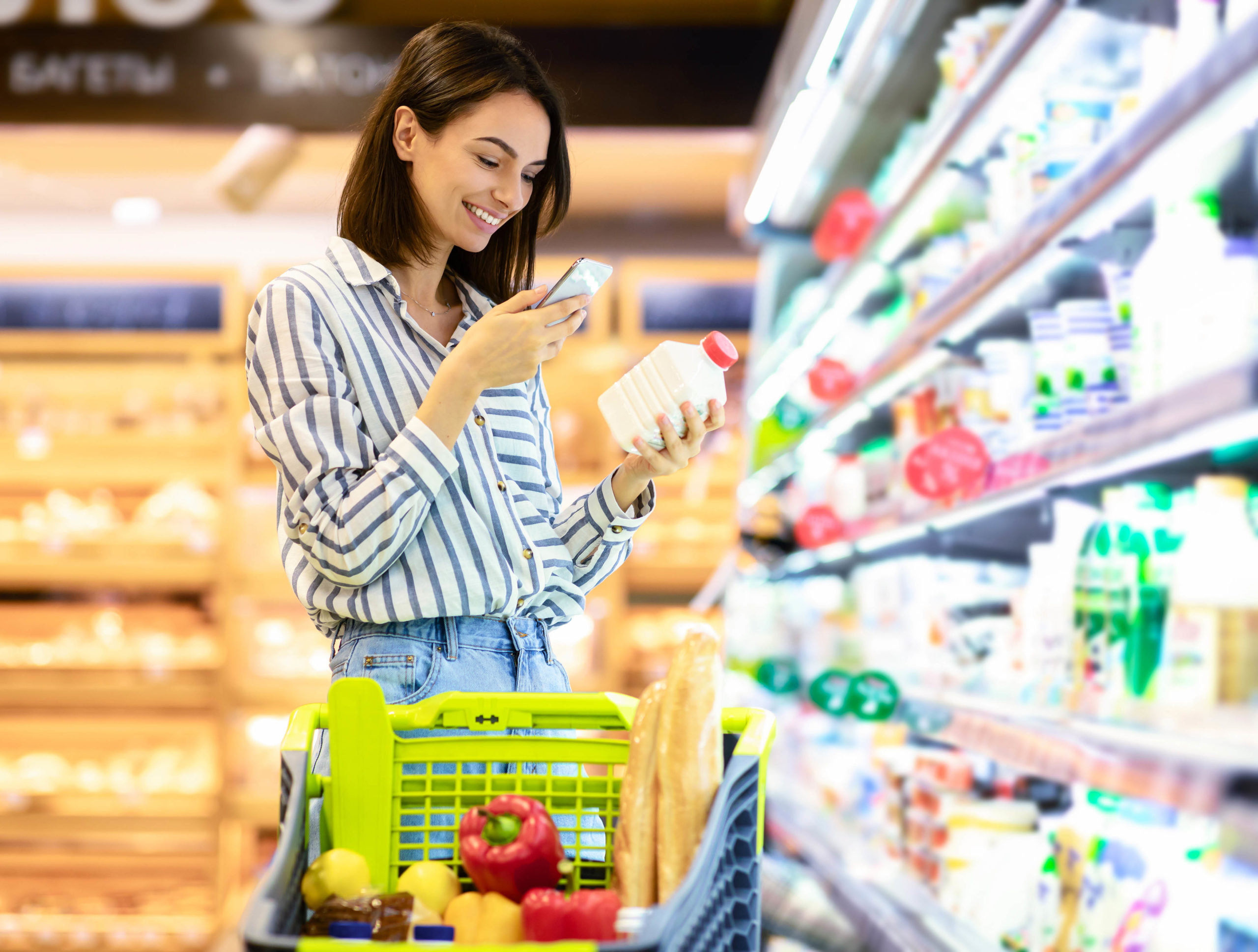Woman scanning code on products using smartphone