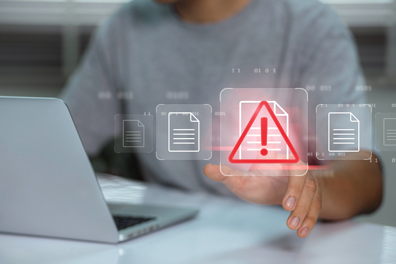 What is an Account Takeover (ATO)? Businessman using laptop with data information privacy and docum